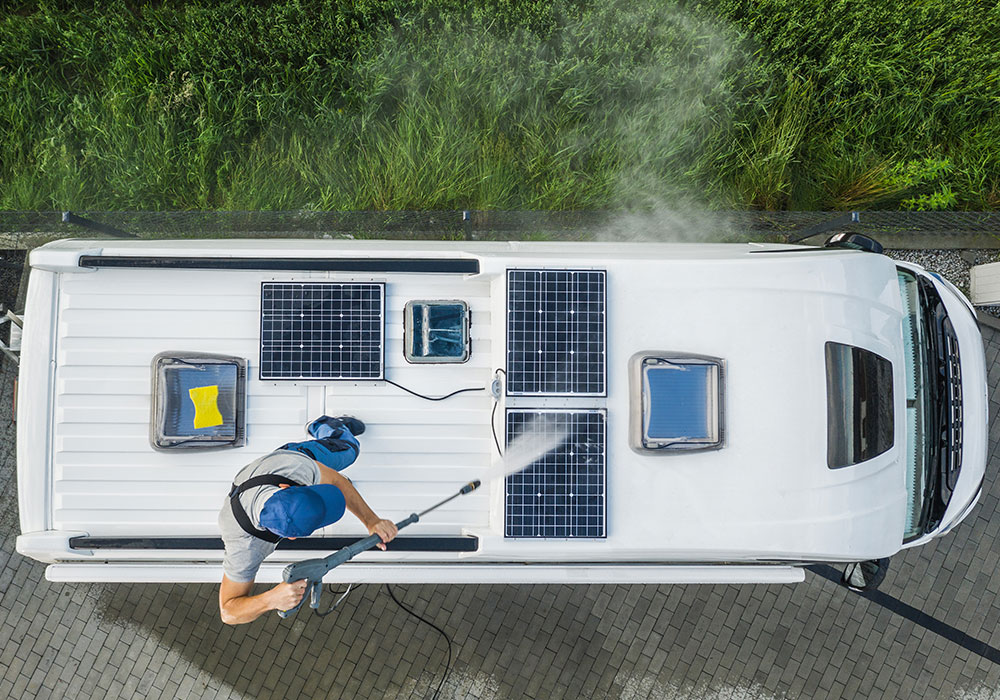 cleaning solar panels on roof of truck