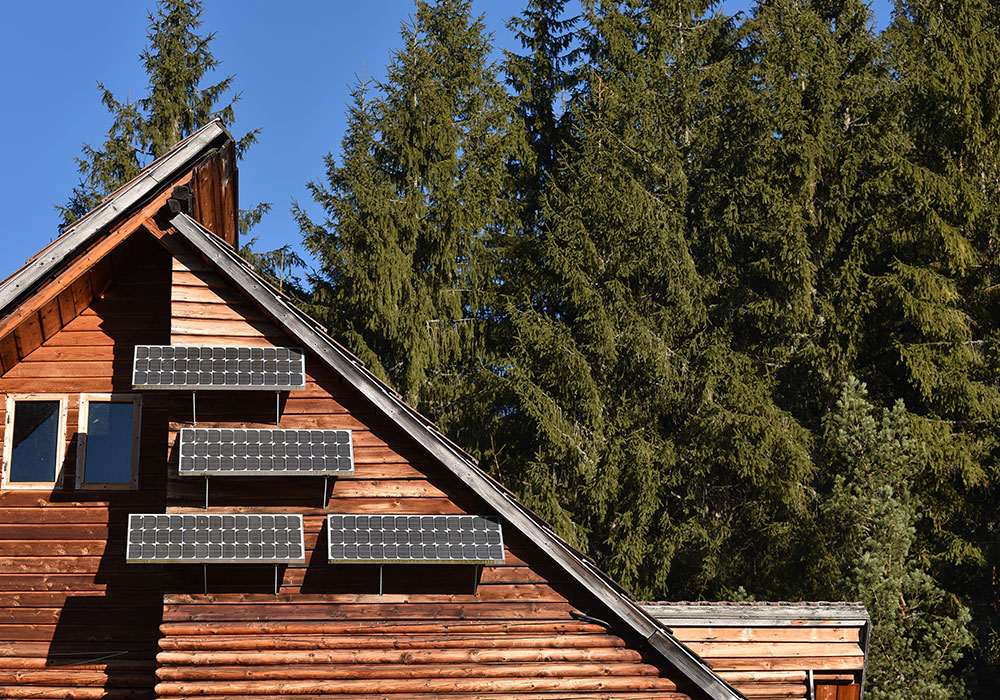 solar panels on side of house in the woods