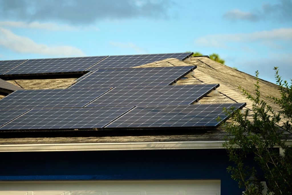 Blue home with black solar panels on roof