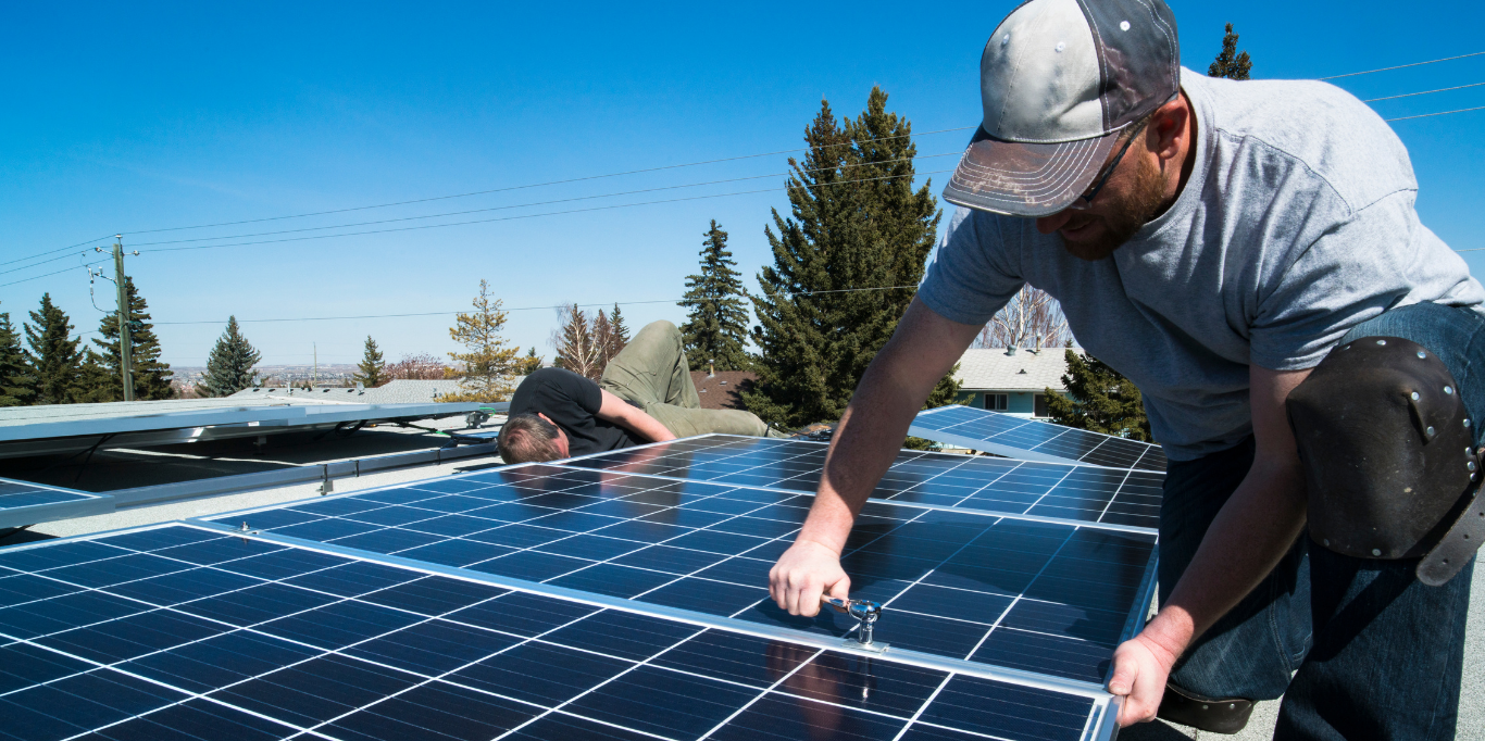 solar crew installing solar panels on roof of house